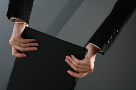 Close up view of hands and documents folderの写真素材