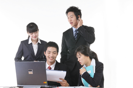 Young Asian business people in the studio - isolated on whiteの写真素材