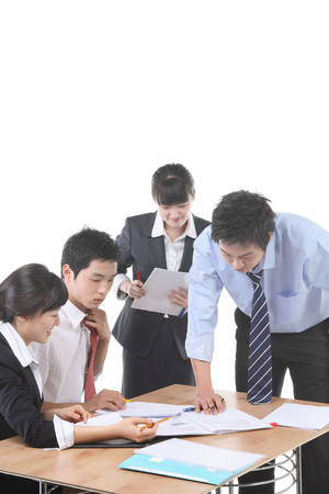 Young Asian business people in the studio - isolated on whiteの写真素材