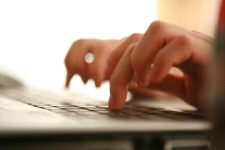 Close up of hands on the computer keyboardの写真素材