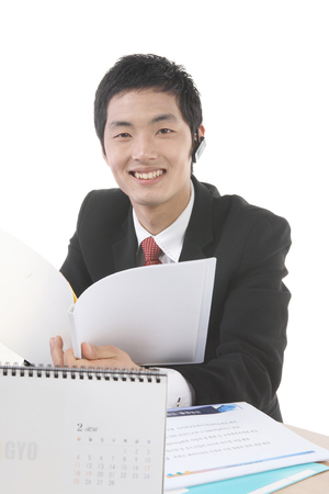 Young Asian business people in the studio - isolated on whiteの写真素材