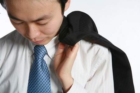 Young Asian businessman in the studio - isolated on whiteの写真素材
