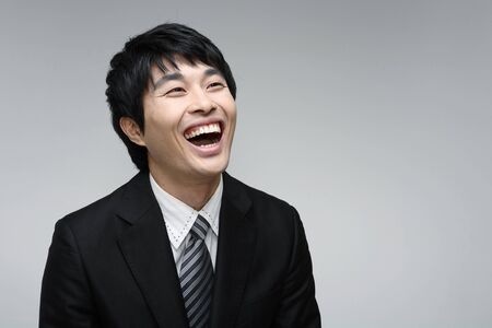 Young Asian man in suit posing in the studio - isolated on white