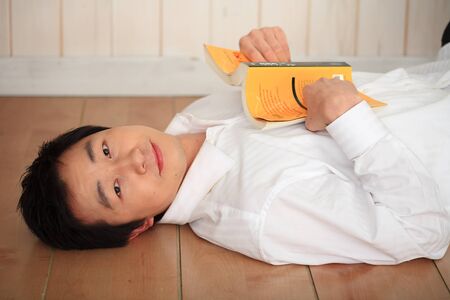 Asian man reading a bookの写真素材