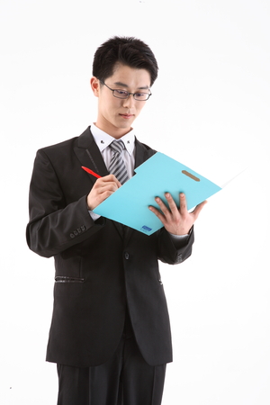 Asian businessman with a folder - isolated on whiteの写真素材