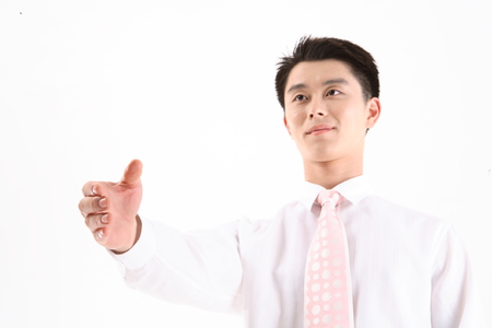 Asian businessman offering handshake - isolated on whiteの写真素材