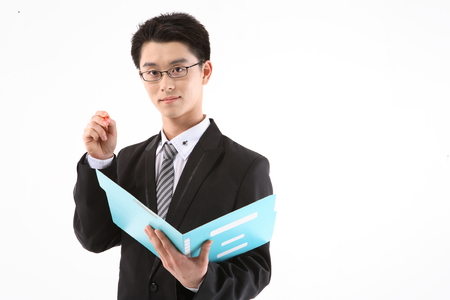 Asian businessman with a folder - isolated on whiteの写真素材