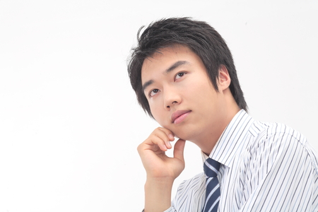 Asian businessman posing in the studio - isolated on whiteの写真素材