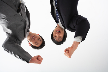 Two Asian businessmen posing in the studio - isolated on whiteの写真素材