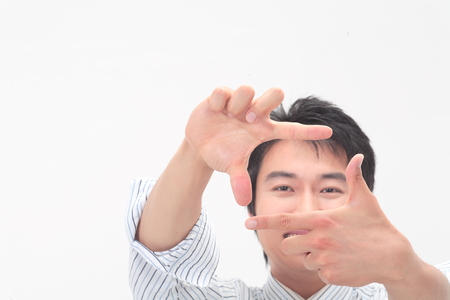 Asian businessman posing in the studio - isolated on whiteの写真素材