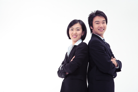 Asian business people standing back to back - isolated on whiteの写真素材