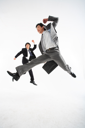 Two Asian businessmen putting posing in the studio - isolated on whiteの写真素材