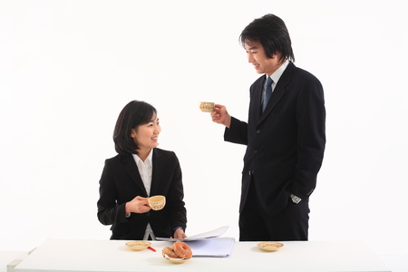 Young Asian business people posing in the studio - isolated on whiteの写真素材
