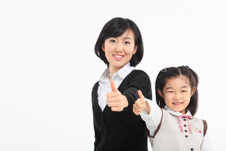 An asian girl and a woman smiling - isolated on whiteの写真素材