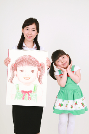 A woman and a little girl posing in the studio - isolated on whiteの写真素材