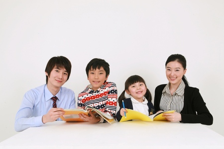 Two teachers and two kids studyingのeditorial素材