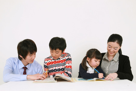 Two teachers and two kids studyingのeditorial素材