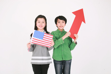 A girl holing up an American flag - isolated on white? ???? ?? ?? ????