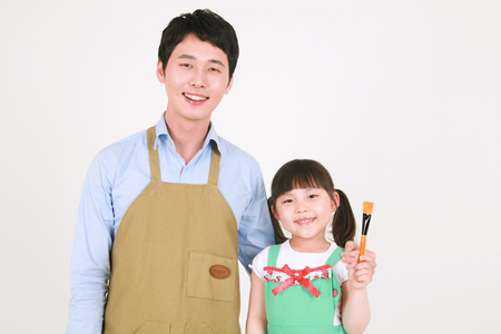 A man and a little girl posing in the studio - isolated on whiteのeditorial素材
