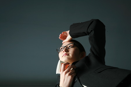 Young Asian business woman posing in the studio - isolated on whiteの写真素材