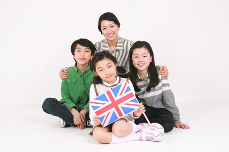 A teacher and three kids - isolated on whiteの写真素材