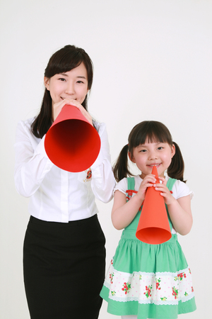 A woman and a little girl posing in the studio - isolated on whiteのeditorial素材