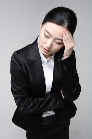 Young Asian businesswoman posing in the studio - isolated on whiteの写真素材