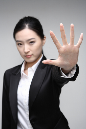 Young Asian businesswoman posing in the studio - isolated on whiteの写真素材