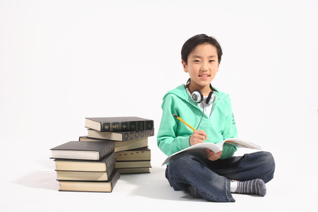 A little boy studying - isolated on whiteの写真素材