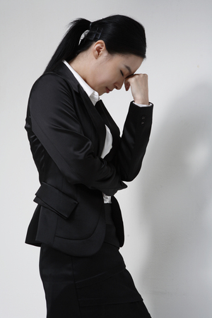 Young Asian businesswoman posing in the studio - isolated on whiteの写真素材