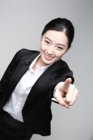 Young Asian businesswoman posing in the studio - isolated on whiteの写真素材