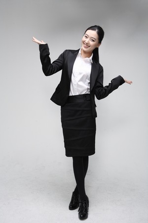 Young Asian businesswoman posing in the studio - isolated on whiteの写真素材