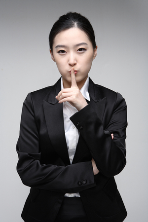 Young Asian businesswoman posing in the studio - isolated on whiteの写真素材