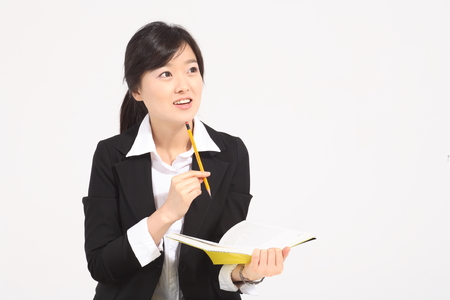 A asian woman studying - isolated on whiteの写真素材