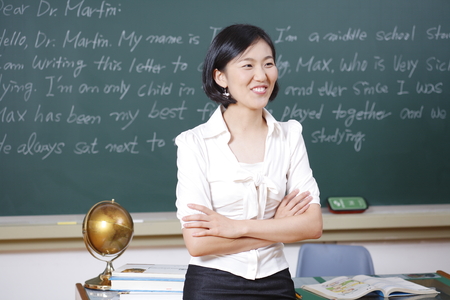 A teacher posing in a high school classroomの写真素材