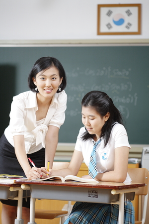A teacher posing in a high school classroomの写真素材