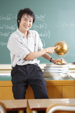 A teacher posing in a high school classroomの写真素材