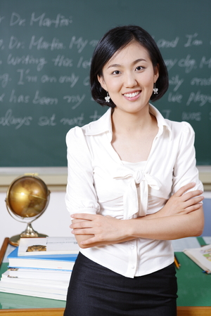 A teacher posing in a high school classroomの写真素材