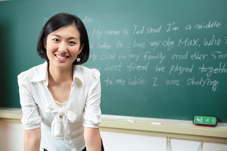 A teacher posing in a high school classroomの写真素材