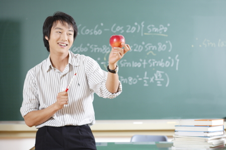 A teacher posing in a high school classroomの写真素材