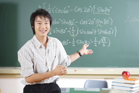 A teacher posing in a high school classroomの写真素材