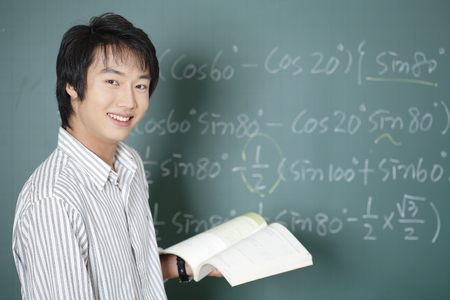 A teacher posing in a high school classroomの写真素材