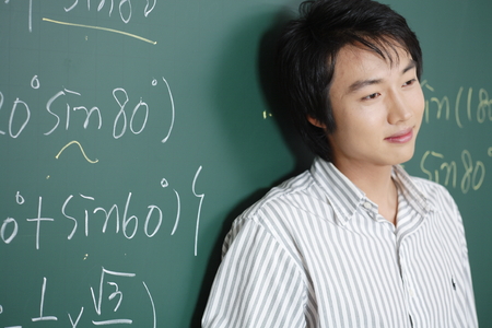 A teacher posing in a high school classroomの写真素材