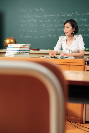 A teacher posing in a high school classroomの写真素材