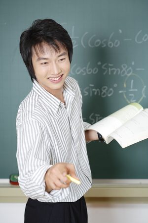 A teacher posing in a high school classroomの写真素材