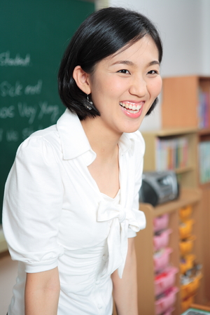 A teacher posing in a high school classroomの写真素材