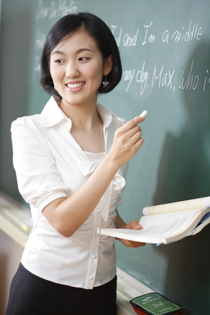 A teacher posing in a high school classroomの写真素材