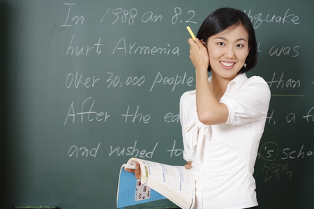 A teacher posing in a high school classroomの写真素材