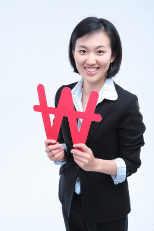 Young Asian businesswoman posing with Korean Won symbol - isolated on whiteの写真素材