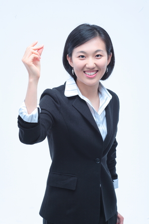 Young Asian businesswoman posing in the studio - isolated on whiteの写真素材